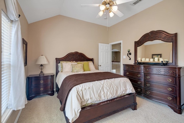 bedroom featuring vaulted ceiling, light carpet, visible vents, and a ceiling fan