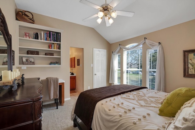 bedroom with lofted ceiling, light carpet, connected bathroom, and ceiling fan