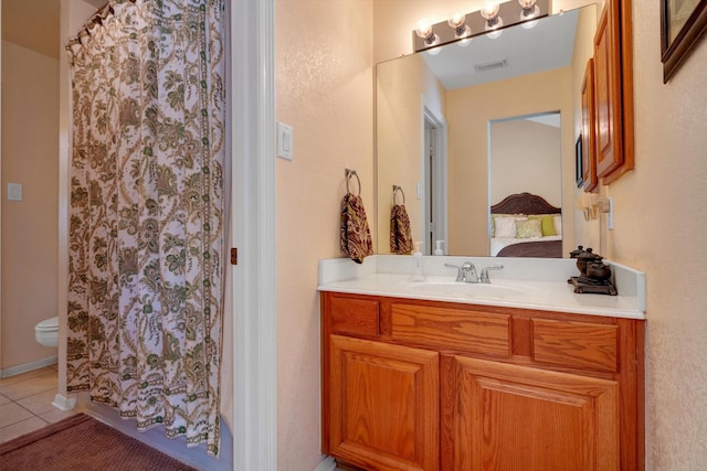 bathroom with tile patterned flooring, connected bathroom, a shower with shower curtain, vanity, and visible vents