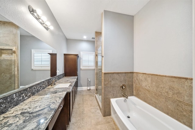 8133 N Fm 565th Rd, Baytown, TX 77523 - bathroom featuring a shower stall, a garden tub, a healthy amount of sunlight, and vanity