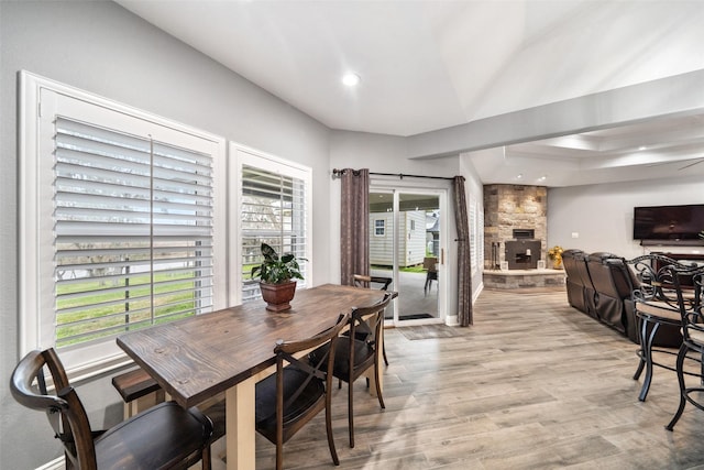 8133 N Fm 565th Rd, Baytown, TX 77523 - dining area featuring a fireplace, recessed lighting, baseboards, and light wood-style flooring