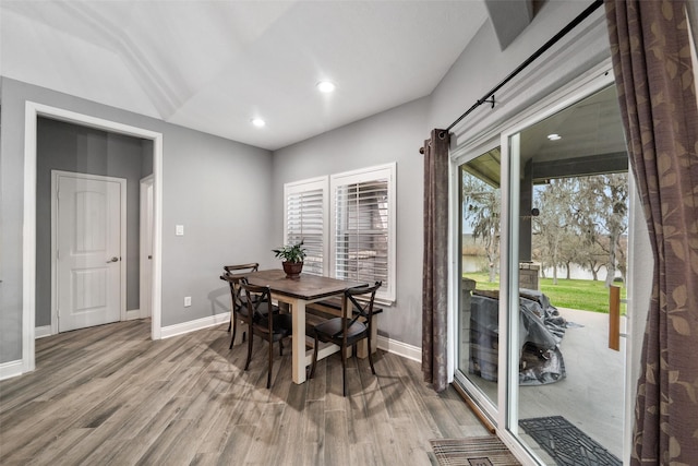 8133 N Fm 565th Rd, Baytown, TX 77523 - dining room featuring recessed lighting, light wood-type flooring, a water view, and baseboards