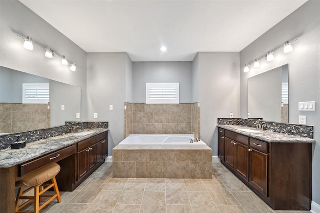 8133 N Fm 565th Rd, Baytown, TX 77523 - bathroom with two vanities, a bath, and a sink