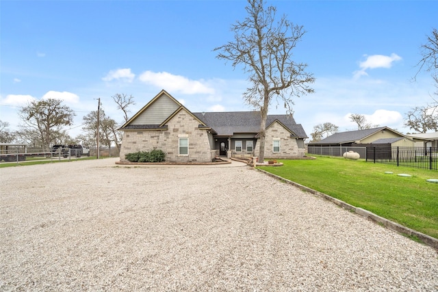 8133 N Fm 565th Rd, Baytown, TX 77523 - view of front of property featuring stone siding, a front lawn, and fence
