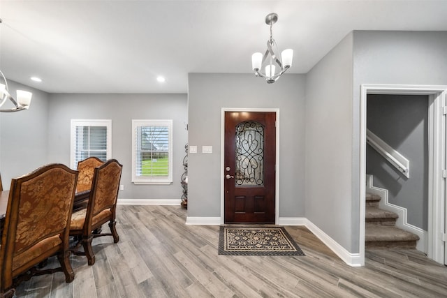 8133 N Fm 565th Rd, Baytown, TX 77523 - entryway featuring baseboards, wood finished floors, a chandelier, and stairway
