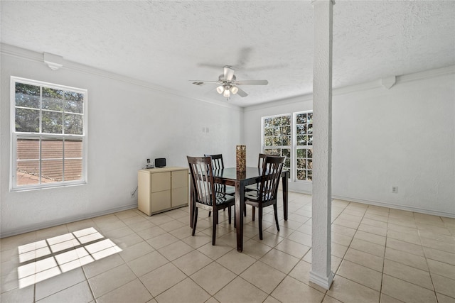 dining area featuring ceiling fan, baseboards, a textured ceiling, and light tile patterned flooring