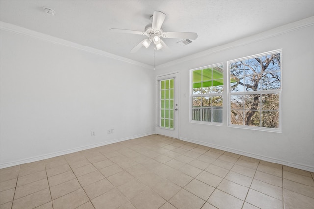 spare room with a ceiling fan, visible vents, crown molding, and baseboards