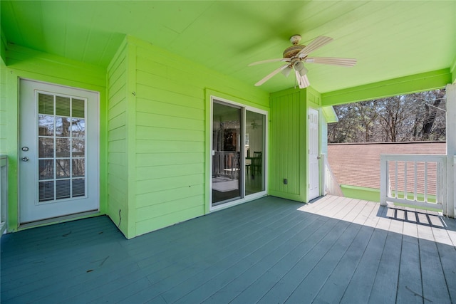 wooden terrace featuring a ceiling fan