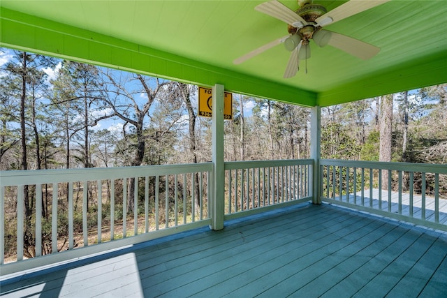 wooden terrace featuring a ceiling fan