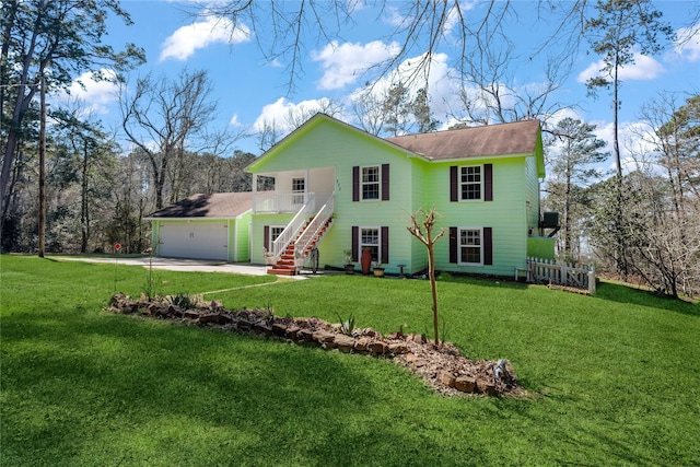 rear view of property featuring a yard, driveway, and an attached garage