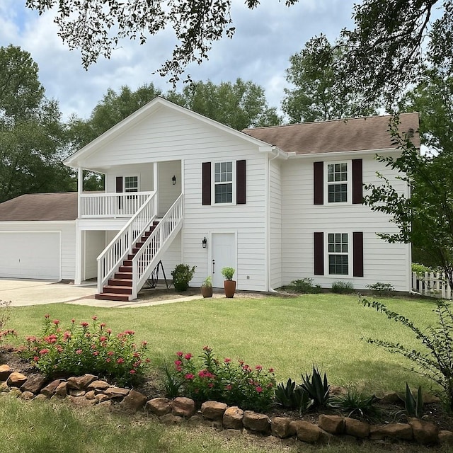 230 Tiki Trl, Livingston, TX 77351 - view of front of house featuring stairway, a porch, a front lawn, roof with shingles, and concrete driveway
