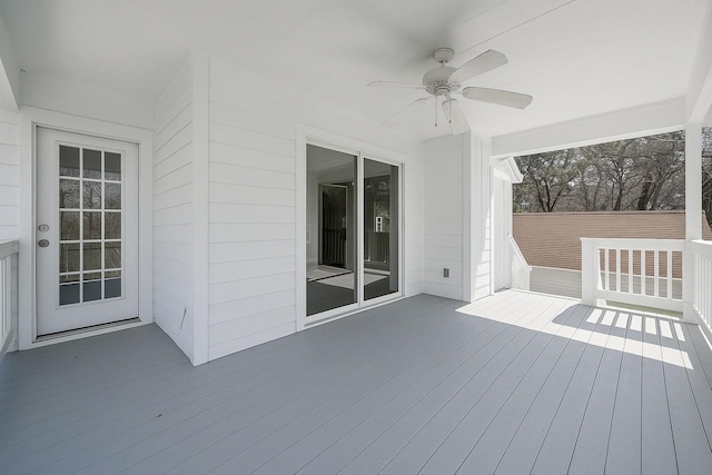 wooden deck featuring ceiling fan