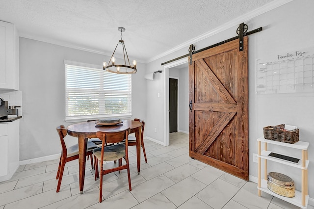 dining room with ornamental molding, a textured ceiling, baseboards, and a barn door