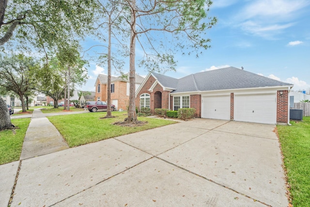 view of front of property featuring a garage, driveway, a front lawn, and brick siding