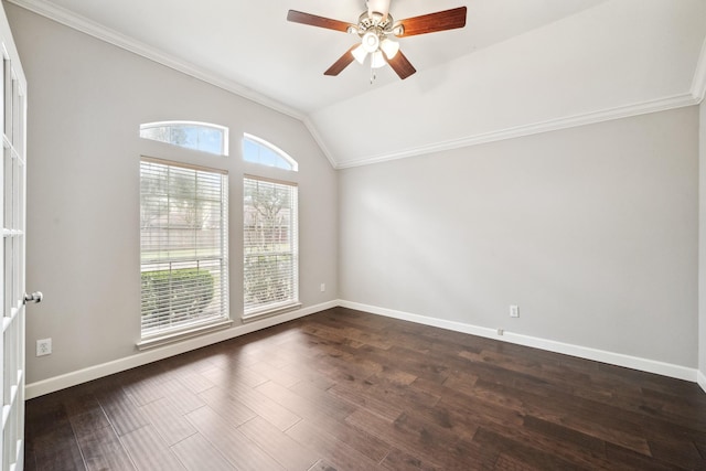 spare room featuring ornamental molding, lofted ceiling, dark wood-style flooring, and baseboards