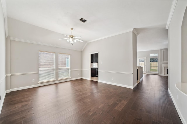 unfurnished living room featuring lofted ceiling, dark wood-type flooring, a fireplace, a ceiling fan, and ornamental molding