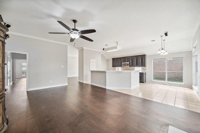 unfurnished living room with light wood-style floors, baseboards, ornamental molding, and ceiling fan with notable chandelier