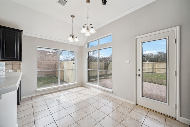 unfurnished dining area with light tile patterned floors, visible vents, a wealth of natural light, an inviting chandelier, and crown molding