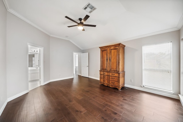 unfurnished living room featuring dark wood-style flooring, visible vents, baseboards, vaulted ceiling, and crown molding