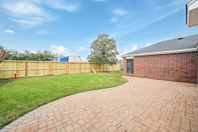 view of yard with a fenced backyard and a patio