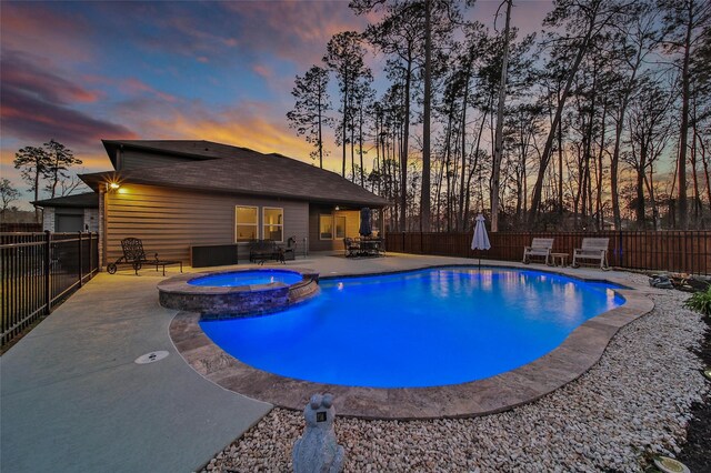 view of swimming pool with a patio area, a fenced backyard, and a pool with connected hot tub