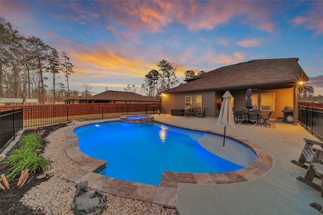 pool at dusk with a patio, outdoor dining space, a fenced backyard, and a pool with connected hot tub