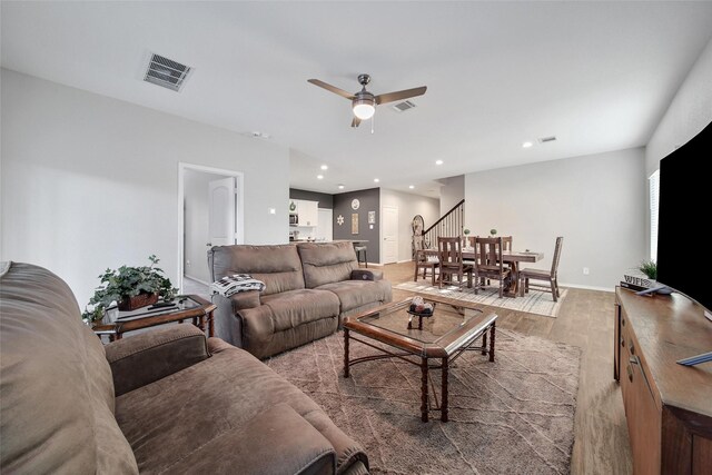 living room with light wood finished floors, stairway, visible vents, and recessed lighting