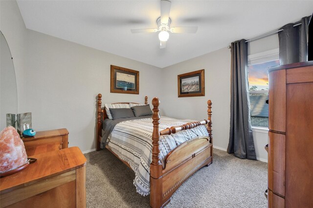 bedroom with carpet, a ceiling fan, and baseboards