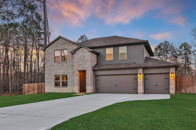 view of front of house with stone siding, fence, driveway, and a lawn