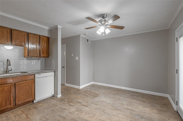 kitchen with visible vents, brown cabinetry, white dishwasher, a sink, and light wood-type flooring