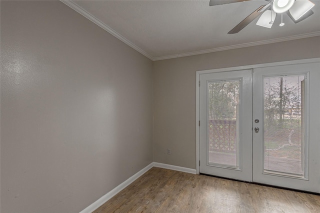 doorway with french doors, ornamental molding, a ceiling fan, wood finished floors, and baseboards