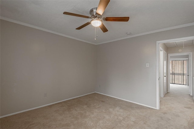 unfurnished room with light carpet, attic access, and ornamental molding