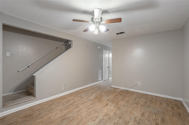 interior space with light wood-style floors, baseboards, stairs, and visible vents