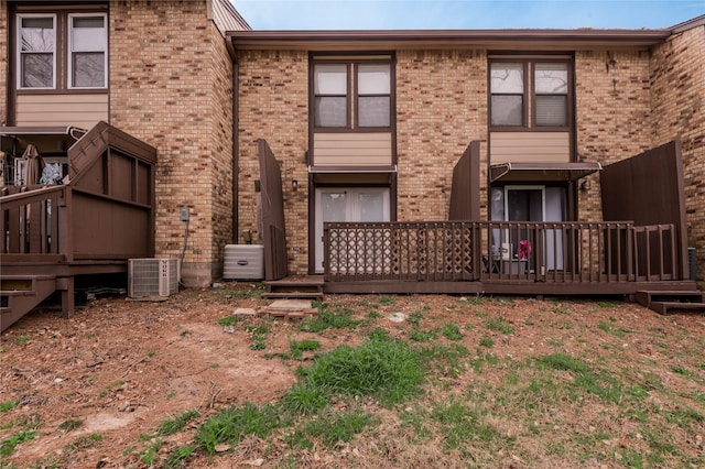 rear view of house with brick siding and central AC unit