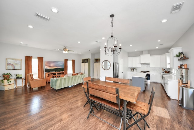 dining area featuring ceiling fan with notable chandelier, visible vents, dark wood-style flooring, and recessed lighting