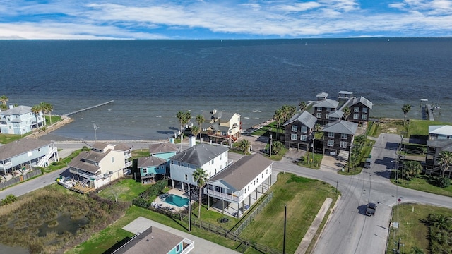 drone / aerial view featuring a water view and a residential view