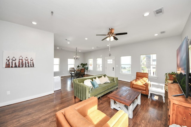 living room with recessed lighting, visible vents, baseboards, and wood finished floors