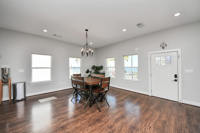 dining space with dark wood-type flooring, recessed lighting, a chandelier, and visible vents