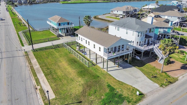 drone / aerial view featuring a residential view and a water view