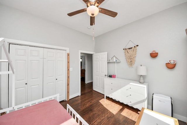 bedroom with a ceiling fan, a closet, dark wood finished floors, and baseboards