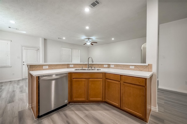 kitchen featuring light countertops, visible vents, dishwasher, and a sink