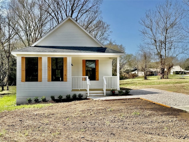 bungalow-style home featuring a porch and a shingled roof