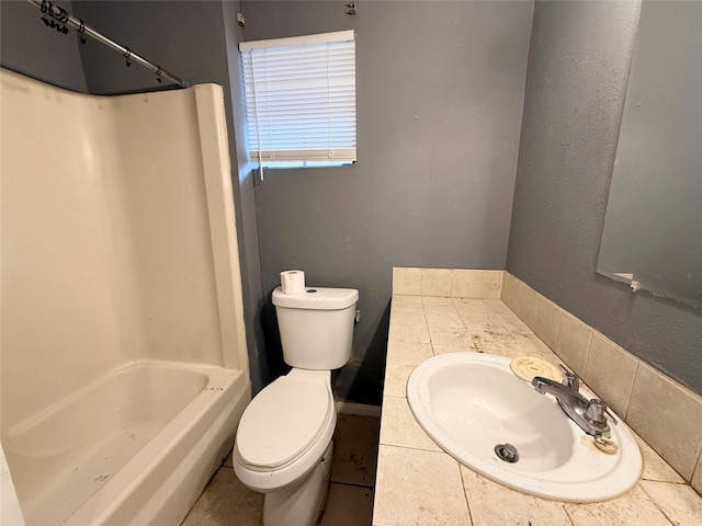 bathroom featuring bathing tub / shower combination, vanity, and toilet