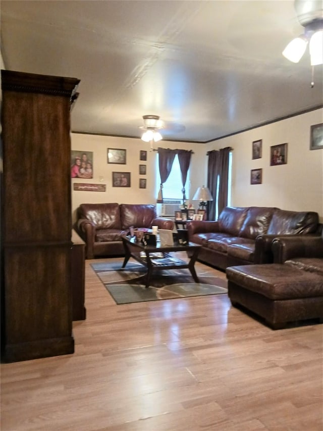 living room with light wood-style flooring and a ceiling fan