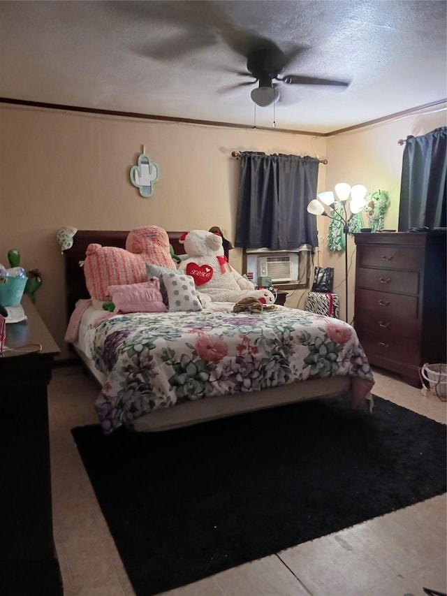 bedroom featuring ceiling fan, a textured ceiling, ornamental molding, and cooling unit