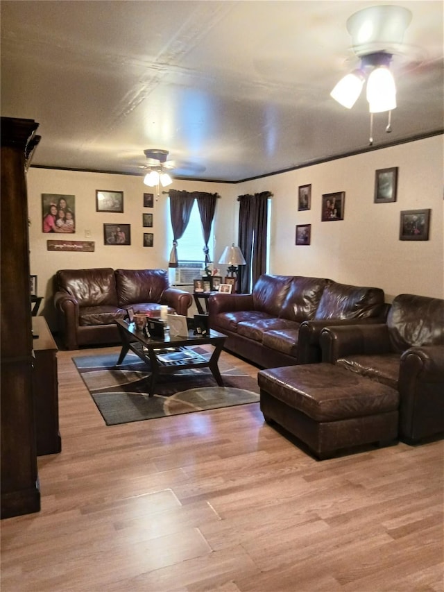 living room featuring crown molding, a ceiling fan, and wood finished floors