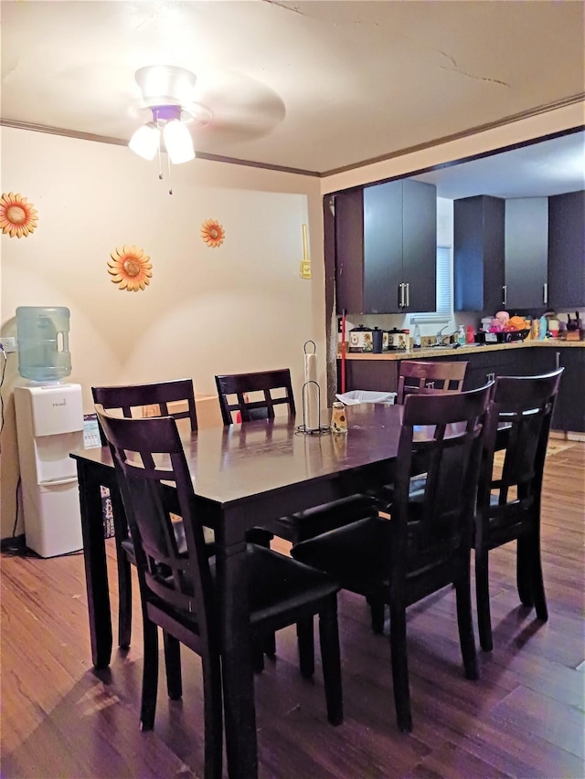 dining room with ornamental molding, ceiling fan, and wood finished floors