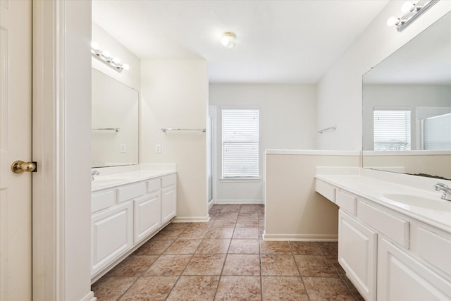 full bath with two vanities, a healthy amount of sunlight, a sink, and a shower stall