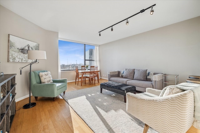 living area with light wood-style flooring and baseboards