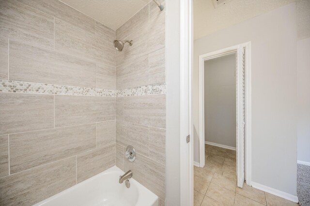 full bathroom featuring tile patterned flooring, bathtub / shower combination, and baseboards